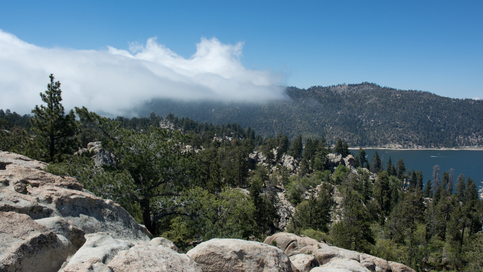 beautiful clouds, trees, rock, and lake