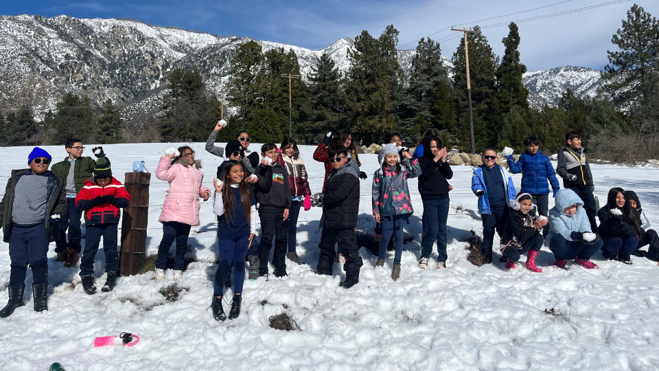 Students playing in the snow at Glen Oak Preserve
